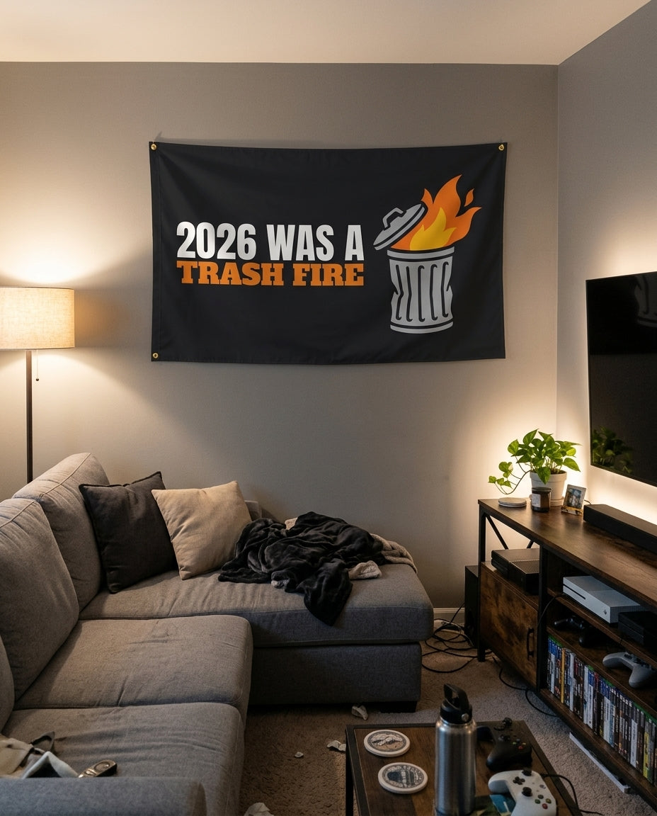 2026 Was A Trash Fire flag decorating a game room wall
