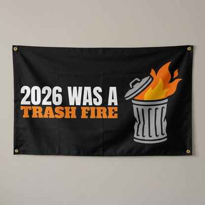 2026 Was A Trash Fire flag 3x5 in black with a burning trash can, hung on a wall