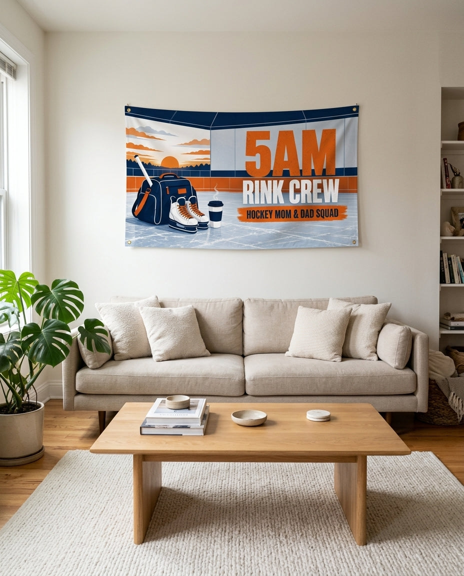 Navy and orange 5AM Rink Crew flag used as living room wall decor