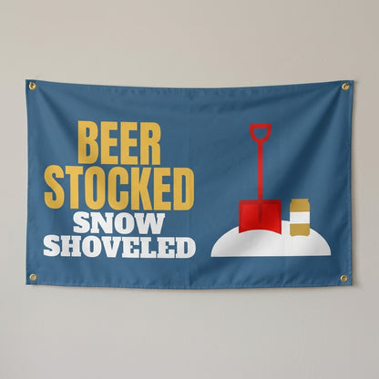 Beer Stocked Snow Shoveled flag 3x5 in steel blue with a snow shovel and beer can, hung on a wall
