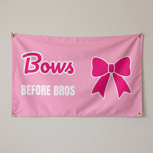 Bows Before Bros flag 3x5 in pink with a hot pink bow, hung on a wall