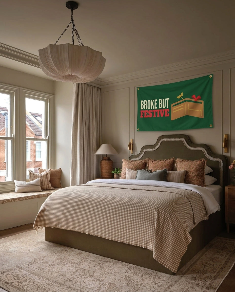Broke But Festive Christmas wall flag hanging in a bedroom