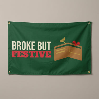 Broke But Festive flag 3x5 in green with an empty wallet with holly, hung on a wall