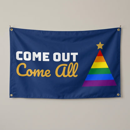 Come Out Come All flag 3x5 in navy with a rainbow Christmas tree, hung on a wall