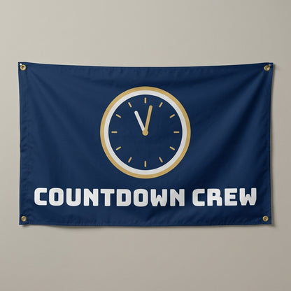 Countdown Crew flag 3x5 in navy and gold with a clock near midnight, hung on a wall
