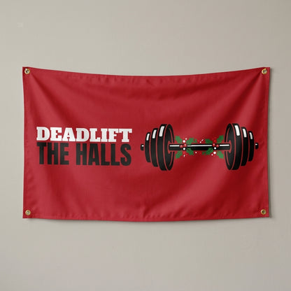 Deadlift The Halls flag 3x5 in red with a barbell wrapped in holly, hung on a wall