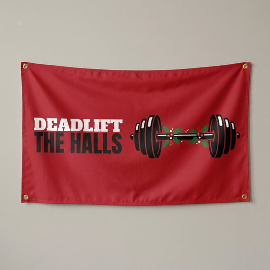 Deadlift The Halls flag 3x5 in red with a barbell wrapped in holly, hung on a wall