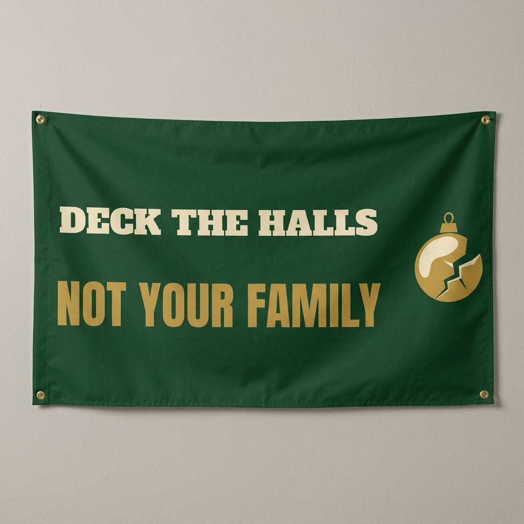 Deck The Halls Not Your Family flag 3x5 in dark green with gold text and a cracked ornament, hung on a wall