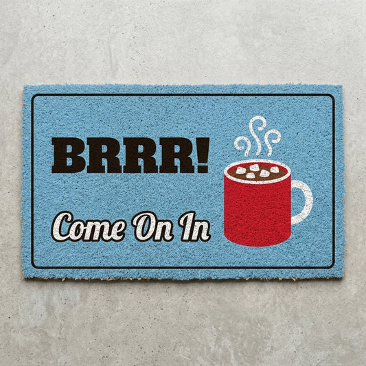 Brrr Come On In doormat 30x18 in light blue with a mug of cocoa