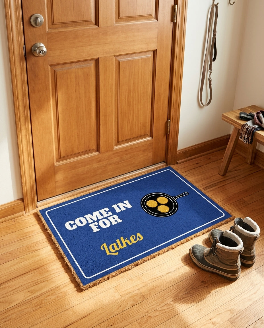 Come In For Latkes welcome mat in a home entryway