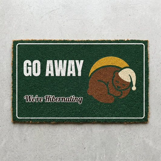 Go Away We're Hibernating doormat 30x18 in green with a sleeping bear in a winter hat