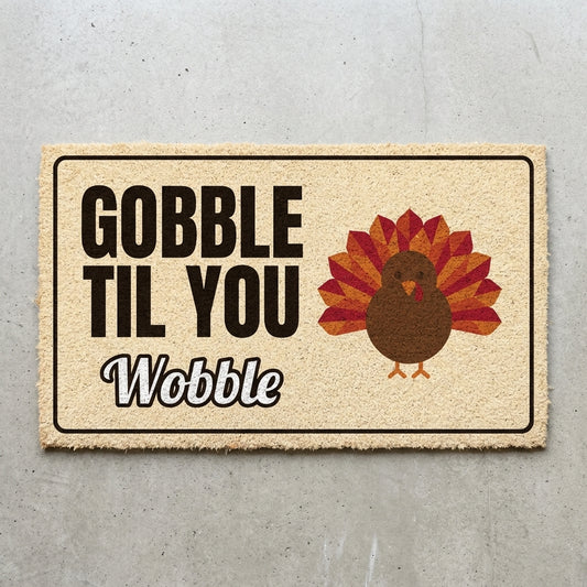 Gobble Til You Wobble doormat 30x18 in cream with a cartoon turkey