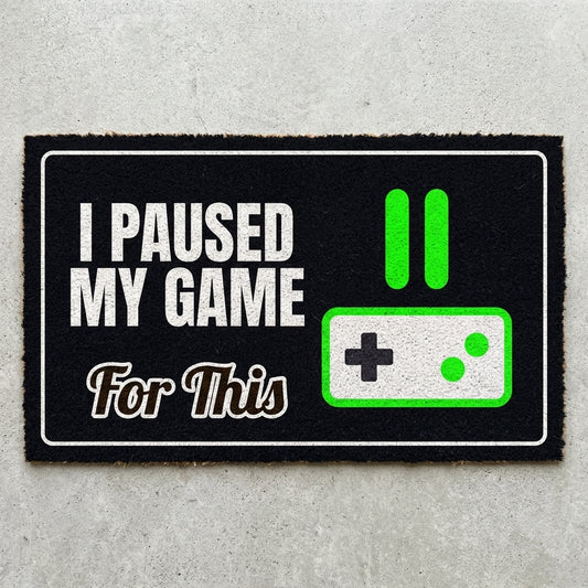 Game Paused For This doormat 30x18 in black with a pause icon