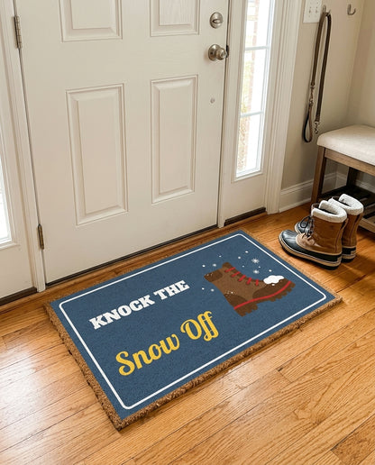 Knock The Snow Off welcome mat in a home entryway