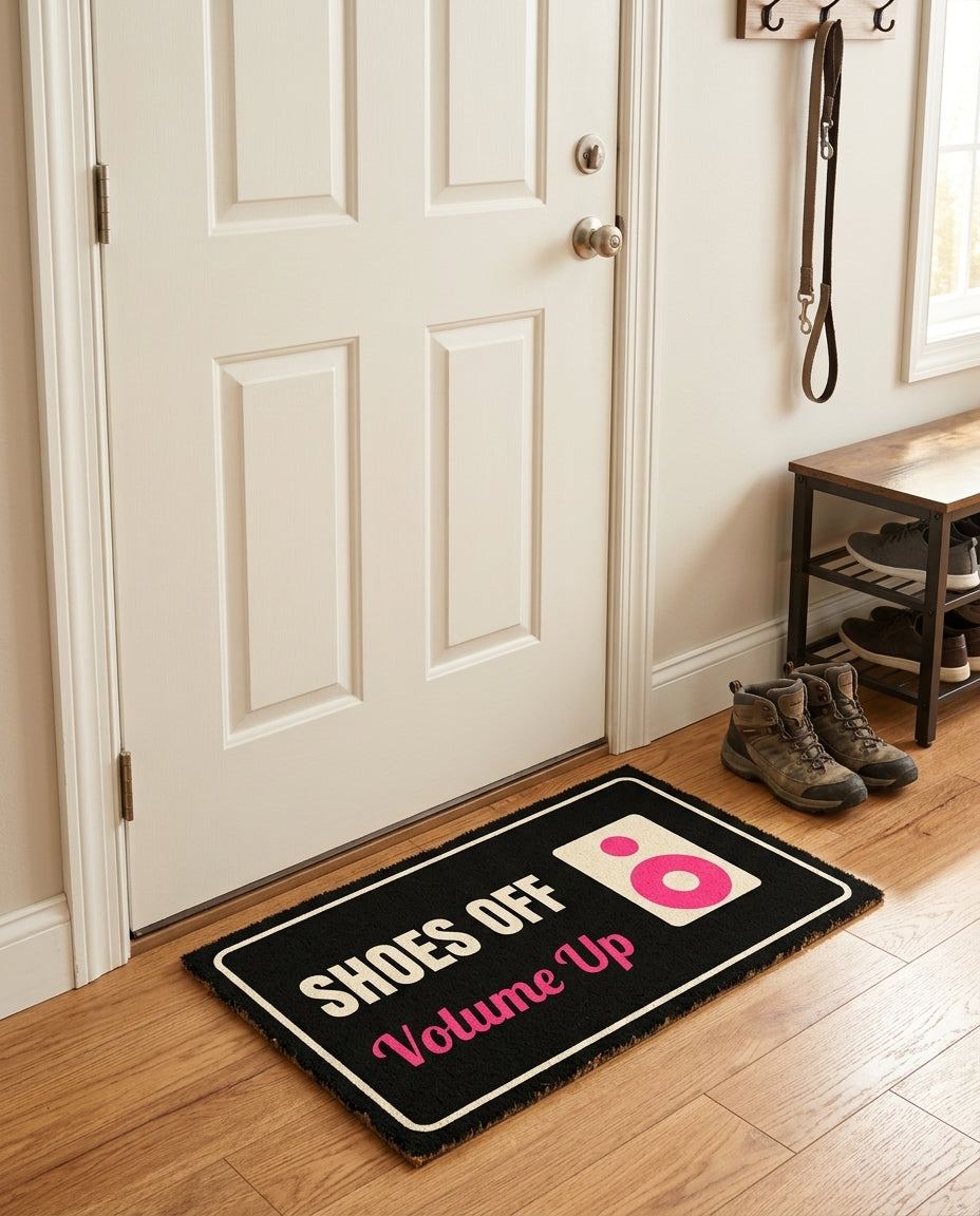 Shoes Off Volume Up welcome mat in a home entryway