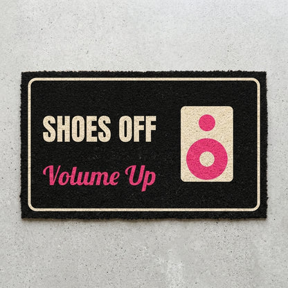 Shoes Off Volume Up doormat 30x18 in black with a speaker