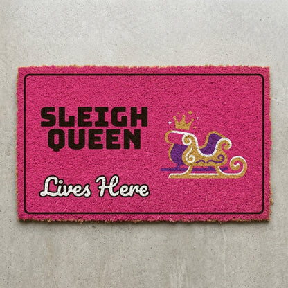 Sleigh Queen Lives Here doormat 30x18 in hot pink with a crowned sleigh