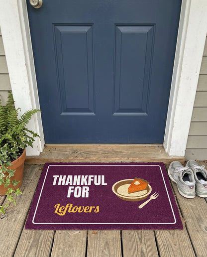 Thankful For Leftovers Thanksgiving doormat on a front porch