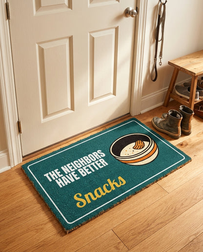 The Neighbors Have Better Snacks welcome mat in a home entryway