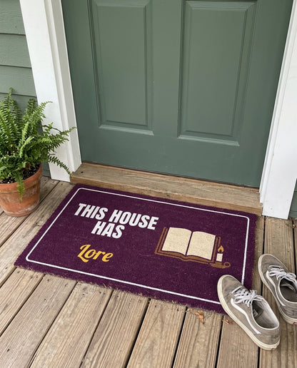 This House Has Lore funny family doormat on a front porch