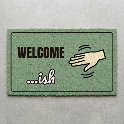 Welcome Ish doormat 30x18 in sage green with a waving hand
