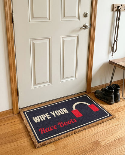 Wipe Your Rave Boots welcome mat in a home entryway