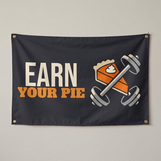 Earn Your Pie flag 3x5 in charcoal with a slice of pie and a barbell, hung on a wall