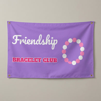 Friendship Bracelet Club flag 3x5 in lavender with a beaded bracelet, hung on a wall