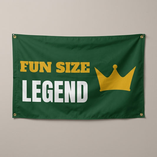 Small But Mighty Legend flag 3x5 in green with a gold crown, hung on a wall