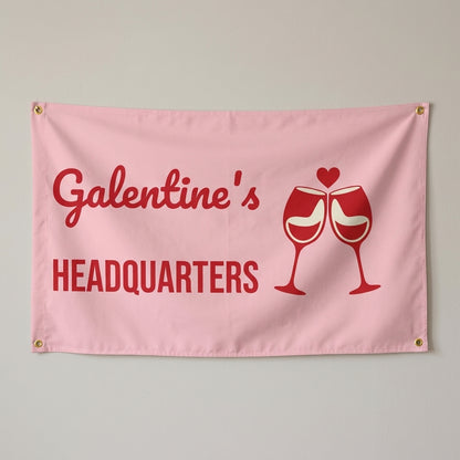 Galentines Headquarters flag 3x5 in pink and red with clinking wine glasses, hung on a wall