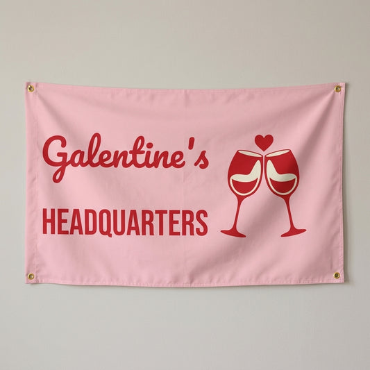Galentines Headquarters flag 3x5 in pink and red with clinking wine glasses, hung on a wall