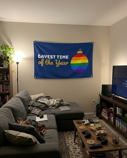 Gayest Time Of The Year flag decorating a game room wall