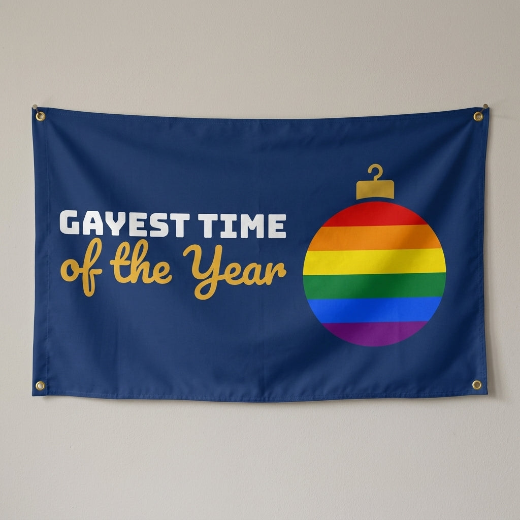 Gayest Time Of The Year flag 3x5 in navy with a rainbow Christmas ornament, hung on a wall