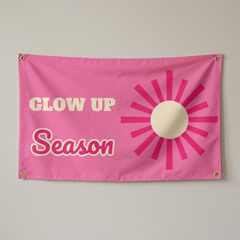 Glow Up Season flag 3x5 in pink with a hot pink sunburst, hung on a wall