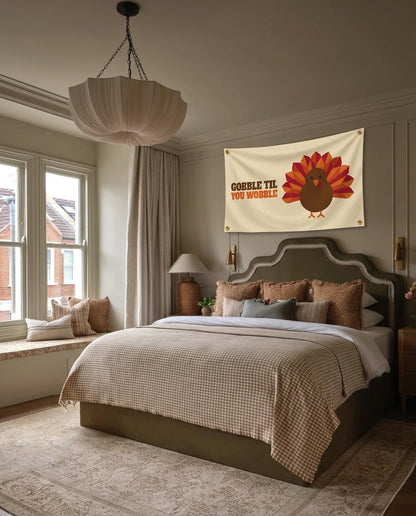 Gobble Til You Wobble Thanksgiving wall flag hanging in a bedroom