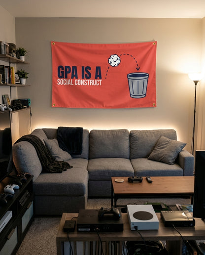 GPA Is A Social Construct flag decorating a game room wall