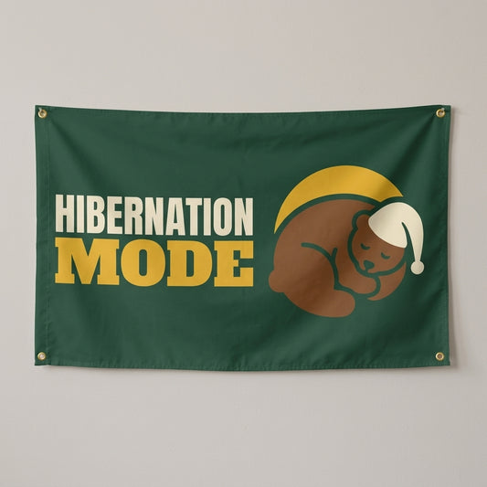 Hibernation Mode flag 3x5 in green with a sleepy bear, hung on a wall
