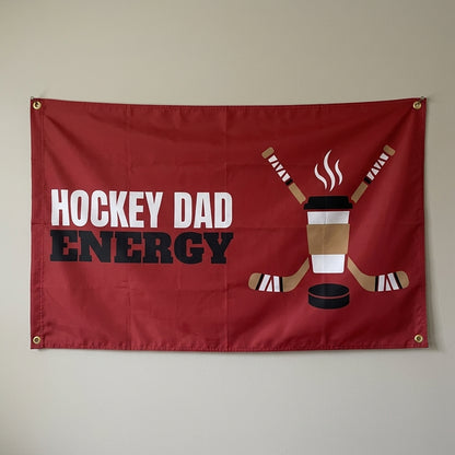 Hockey Dad Energy flag 3x5 in red with a coffee cup and hockey sticks, hung on a wall