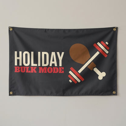 Holiday Bulk Mode flag 3x5 in charcoal with a dumbbell and a drumstick, hung on a wall