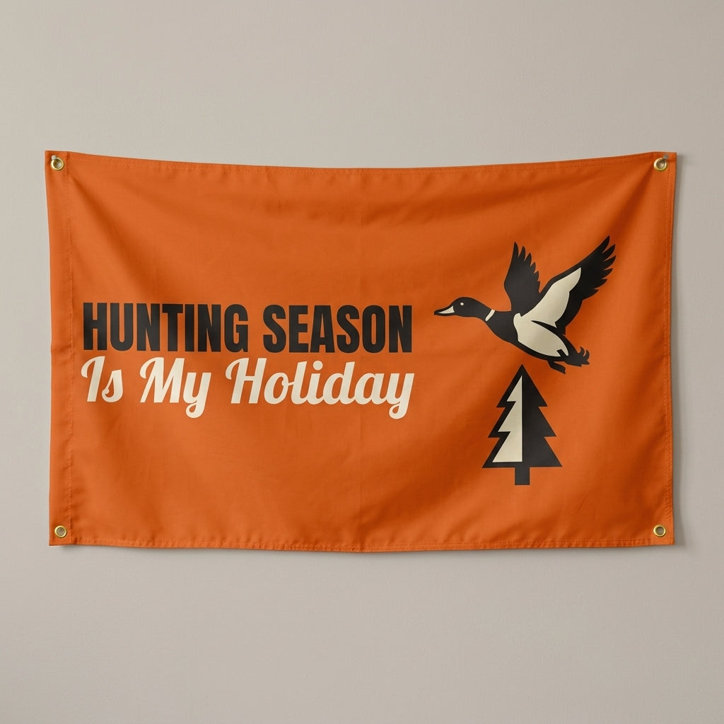 Hunting Season Is My Holiday flag 3x5 in orange with a flying duck and a pine tree, hung on a wall