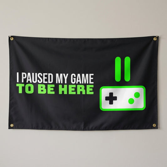 Game Paused For This flag 3x5 in black with a pause icon and controller, hung on a wall