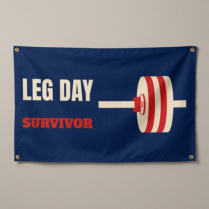 Leg Day Survivor flag 3x5 in navy with a cream and red barbell, hung on a wall