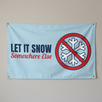 Let It Snow Somewhere Else flag 3x5 in light blue with a crossed out snowflake, hung on a wall