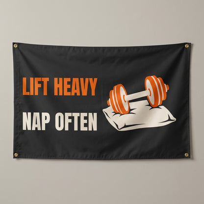 Lift Heavy Nap Often flag 3x5 in black with an orange dumbbell on a pillow, hung on a wall