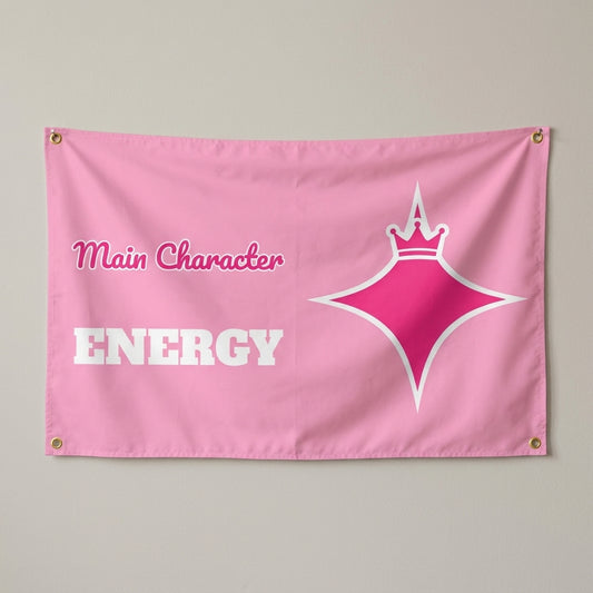 Main Character Energy flag 3x5 in pink with a hot pink crowned star, hung on a wall