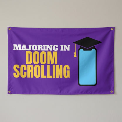 Majoring In Doomscrolling flag 3x5 in purple with a phone in a graduation cap, hung on a wall