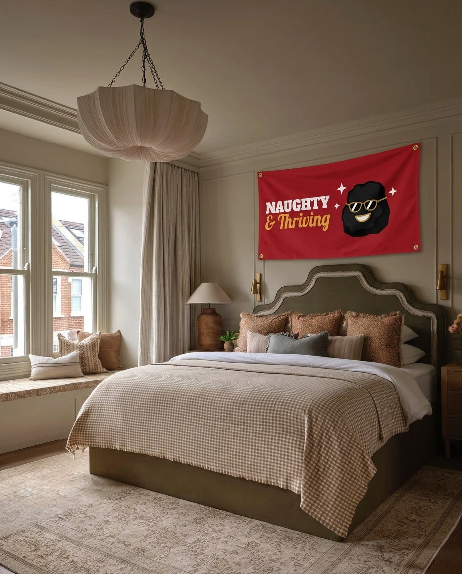 Naughty And Thriving Christmas wall flag hanging in a bedroom