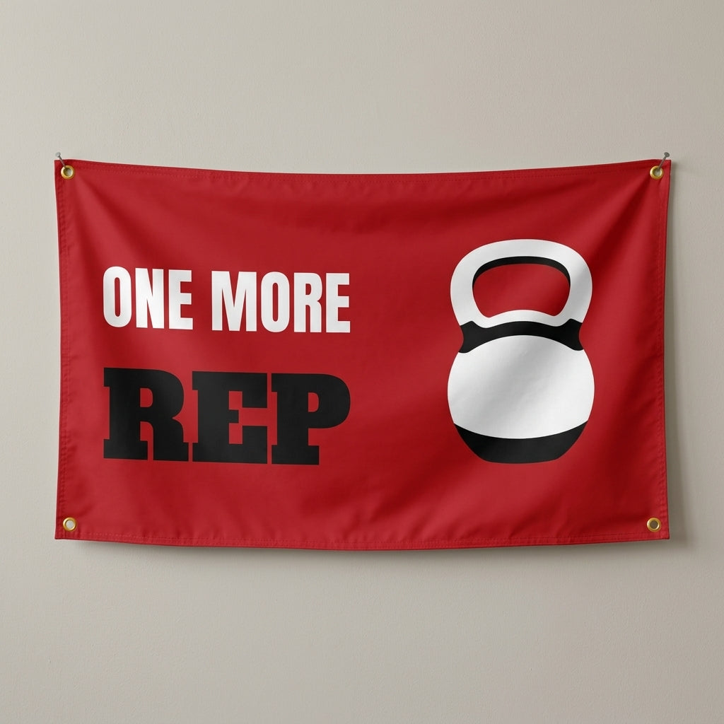 One More Rep flag 3x5 in red with a white kettlebell, hung on a wall