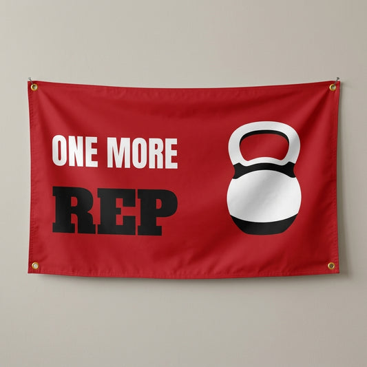 One More Rep flag 3x5 in red with a white kettlebell, hung on a wall