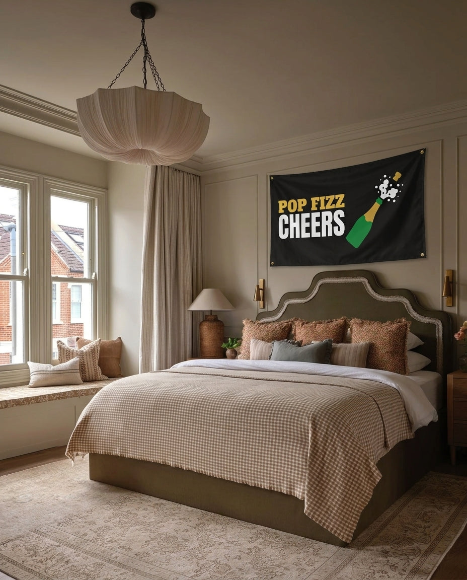 Pop Fizz Cheers New Year's Eve wall flag hanging in a bedroom
